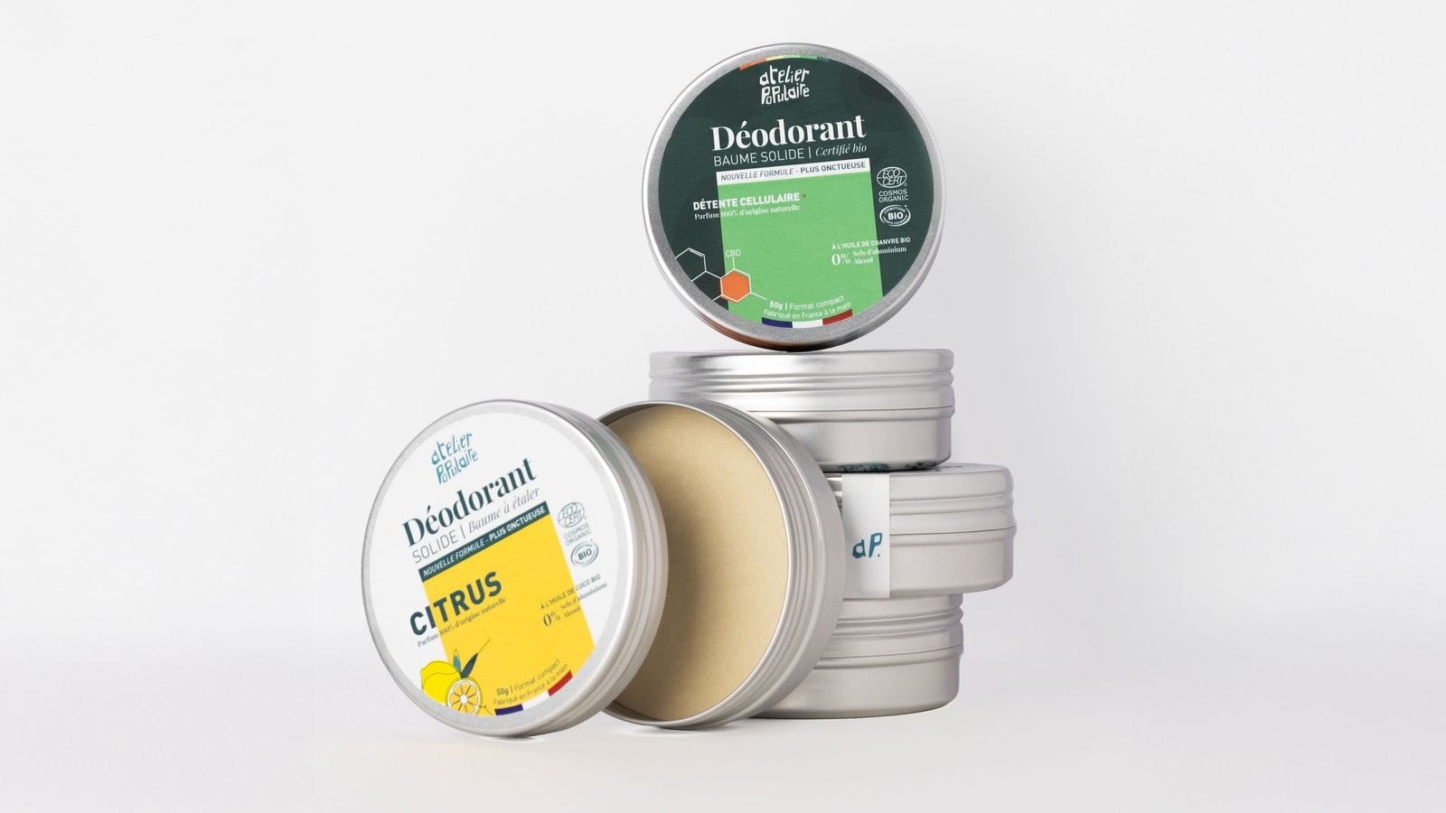 Several Atelier Populaire solid deodorant tins, including an open tin